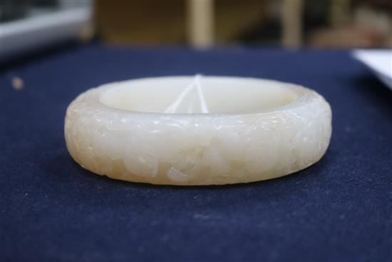 A Chinese white and russet jade bangle